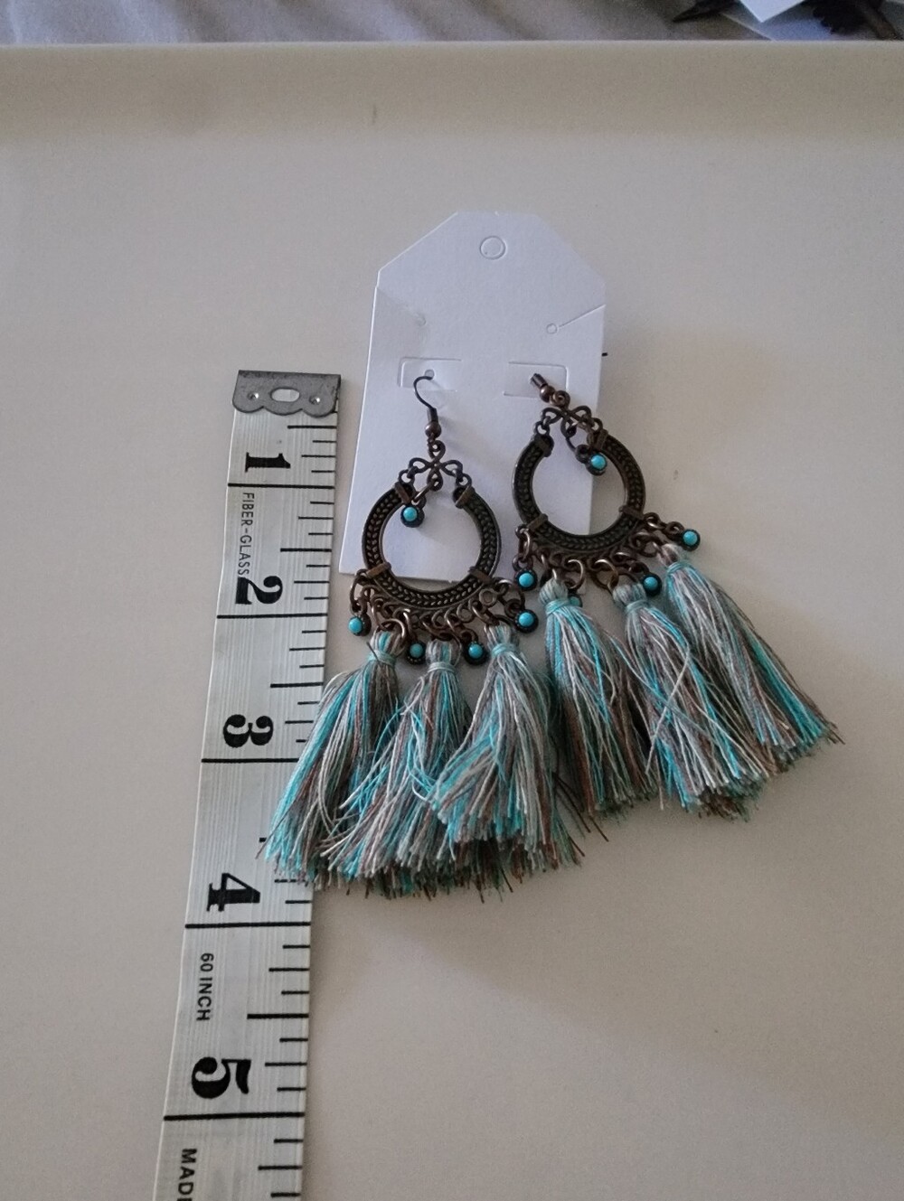 These are Boho-style dangle earrings featuring bronze-toned faux torquise beads